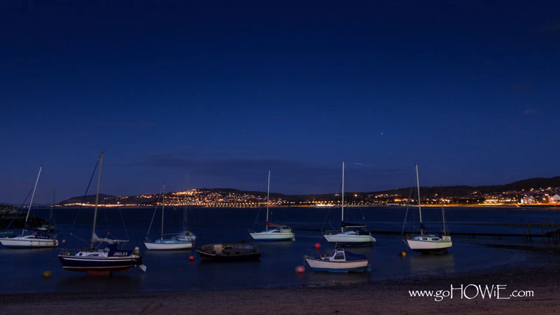 The harbour at Rhos-on-Sea with yachts at dusk on the North Wales coast