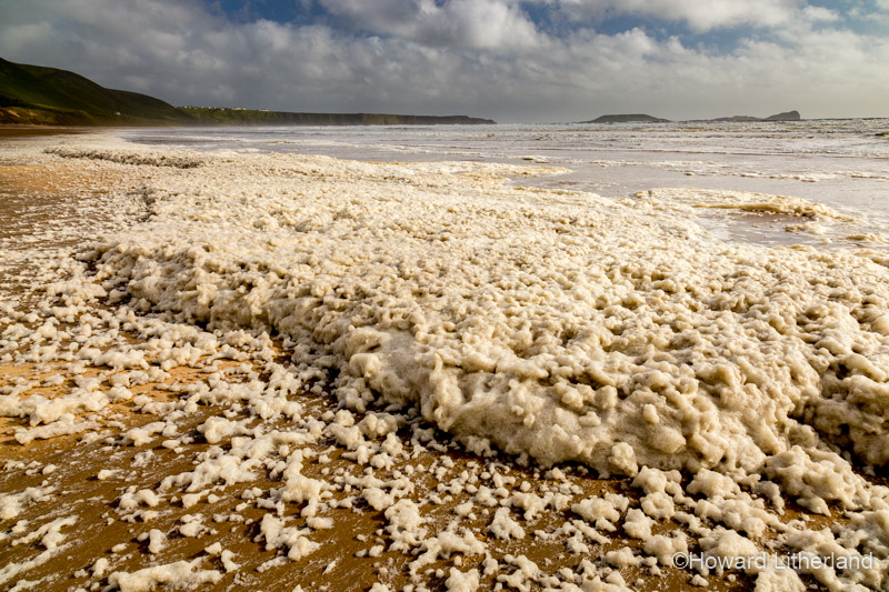 Foam pollution on Rhossili Beach, Gower Peninsula, South Wales coast