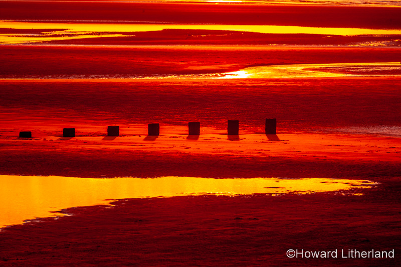 Sunset over Rhyl beach at low tide on the North Wales coast