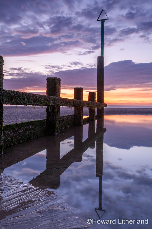 Sunset over Rhyl beach at low tide on the North Wales coast