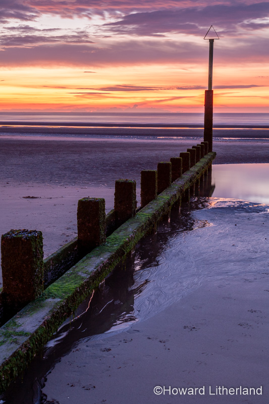 Sunset over Rhyl beach at low tide on the North Wales coast