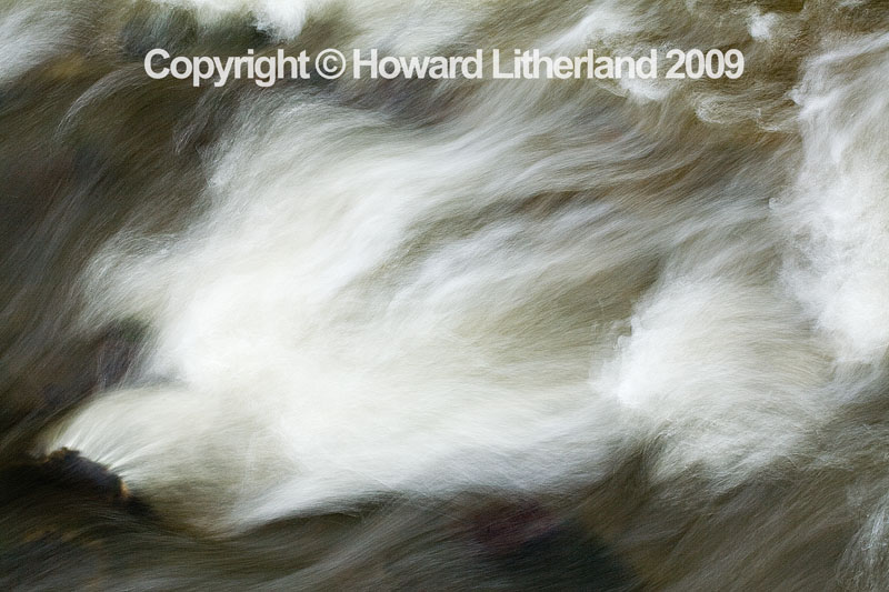 Wave breaking over a rock in a river bed