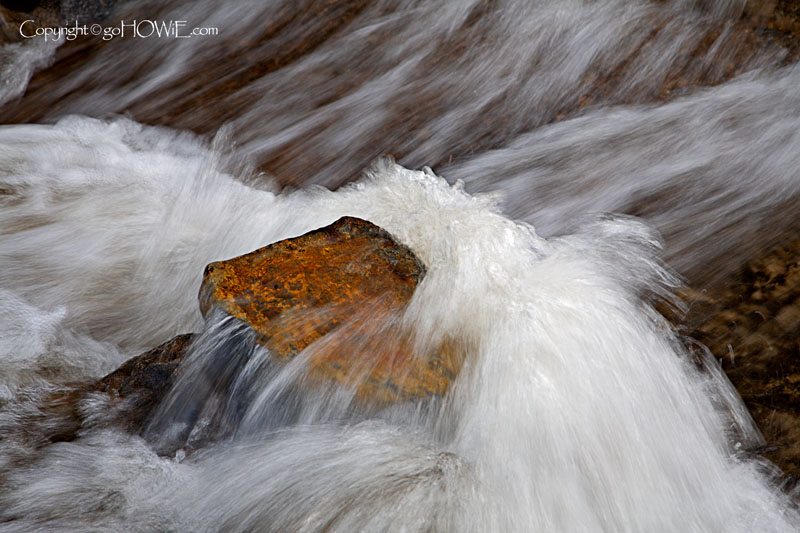 Rock in a flowing stream, Llyn Geirionydd in Snowdonia, North Wales