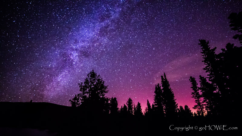 Milky way over pine trees at Sprague Lake in the Rocky Mountains, Colorado, U.S.A.