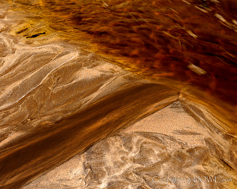 Patterns in the sand and running water on the beach at Solva on the Pembrokeshire coast, Wales