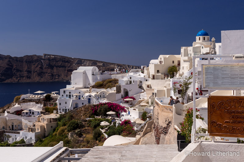 White painted buildings overlooking the Aegean sea at Oia on the island of Santorini