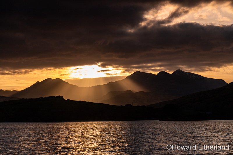 Snowdon mountain with sunbeams at sunset, Snowdonia, North Wales