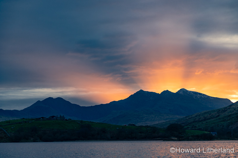 Snowdon mountain with sunbeams at sunset, Snowdonia, North Wales