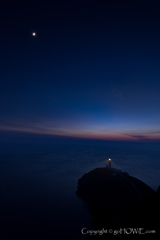 South Stack lighthouse and moon at twilight, Anglesey, Wales