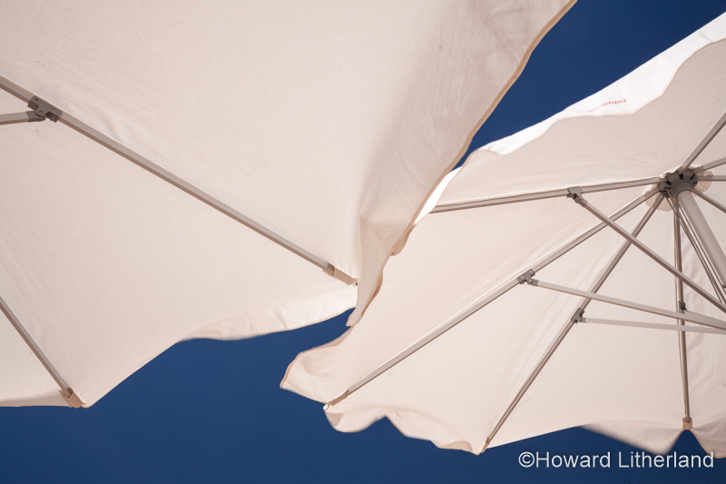 White parasols on the beach at Cadiz, Spain