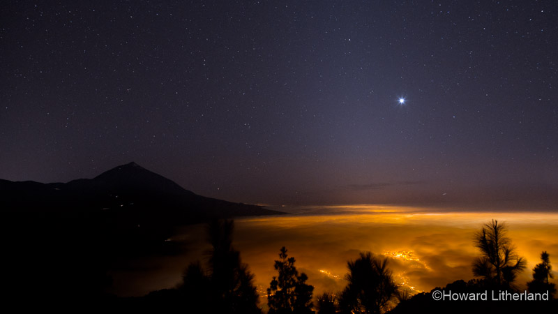 Underlit billowing cloud with Mount Teide in the background and the planet Venus in the sky. Teide National Park, Tenerife, Canary Islands