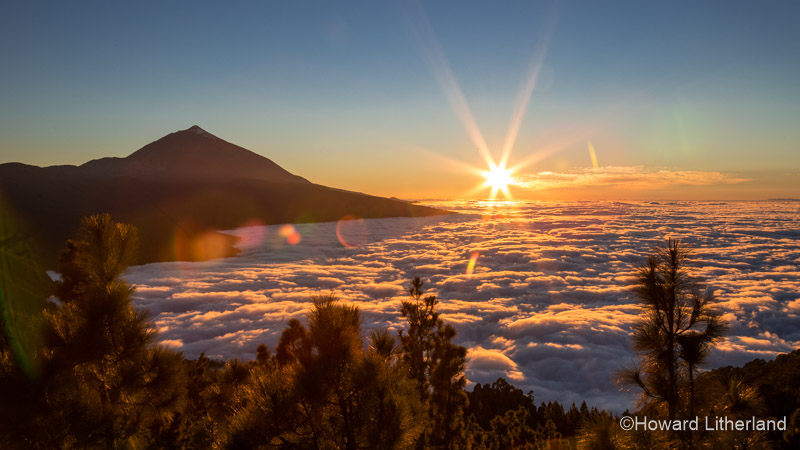 Sun setting over billowing cloud with Mount Teide in the background. Teide National Park, Tenerife, Canary Islands
