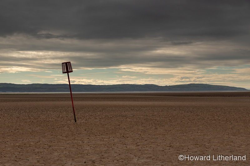 Marker post in the sand at West Kirby, Wirral, England