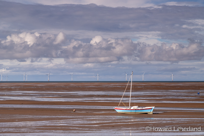 Sailing boat on the beach at low tide at Meols on the Wirral, England