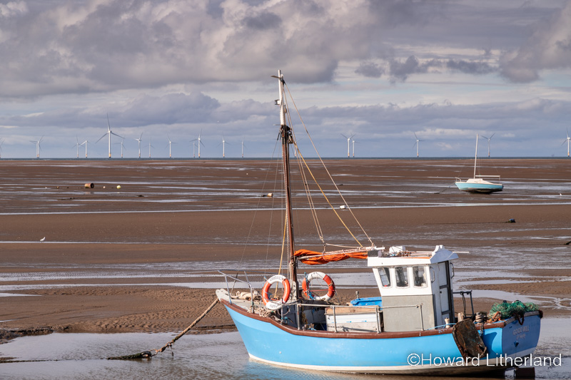 Fishing boat on the beach at low tide at Meols on the Wirral, England