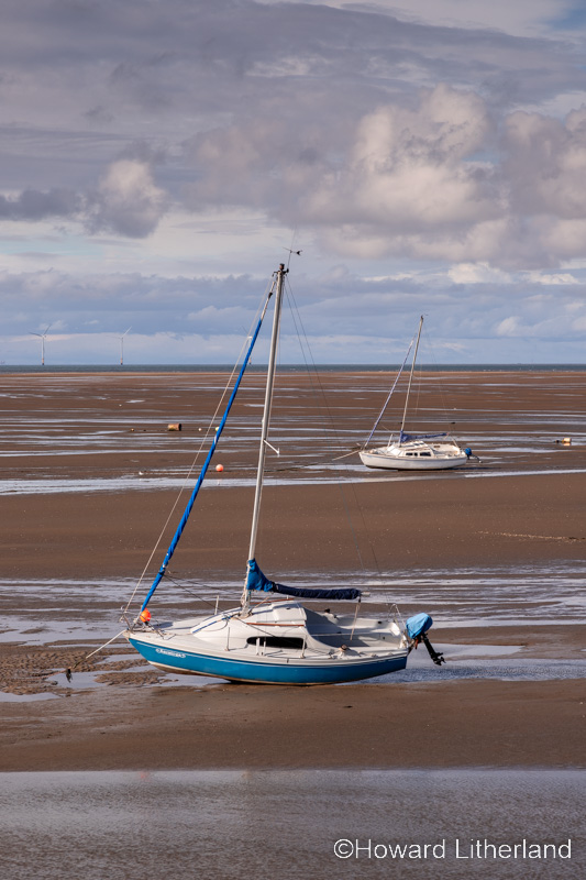 Sailing boat on the beach at low tide at Meols on the Wirral, England
