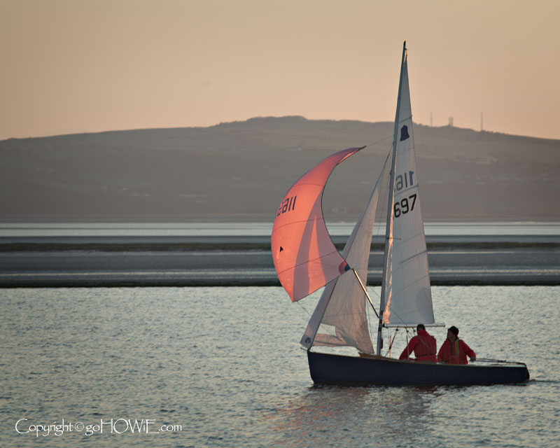Yacht with sunlit sail