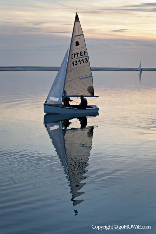 Yacht becalmed at sunset on the Marine Lake, West Kirby, Wirral
