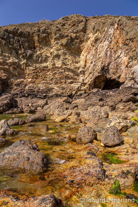 Cliffs and cave at Ynys-y-Fydlyn on the coast of Anglesey, North Wales