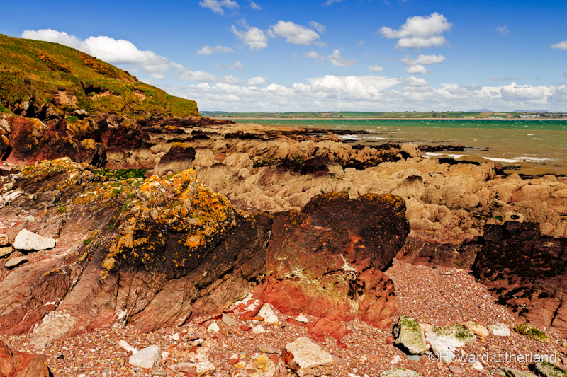 Colourful rocks on the shoreline at Knockadoon near Youghal, County Cork, Ireland